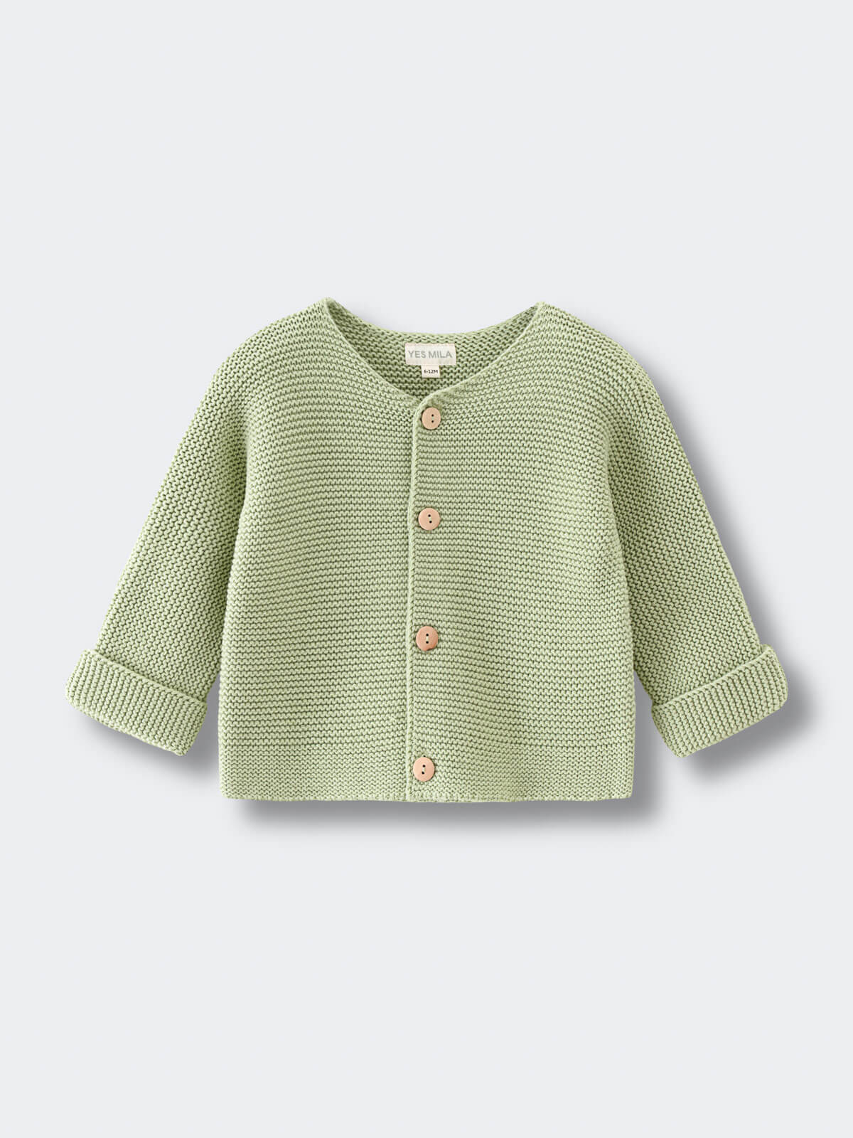 Green baby knitted cotton cardigan on a light gray background