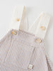 Close-up of striped dungarees with white straps and cream buttons Baby Dungarees - Sand Stripe Baby boy