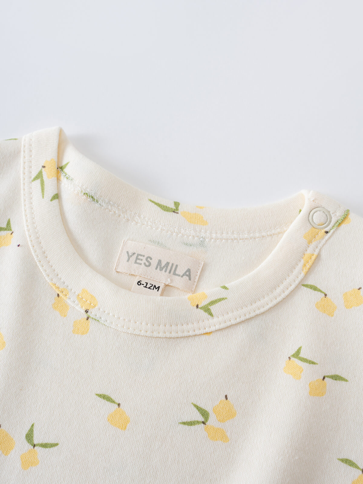 Close-up of cream-colored baby shirt collar with yellow lemon print pattern Baby Printed Short Sleeve Tee- Lemons Baby girl