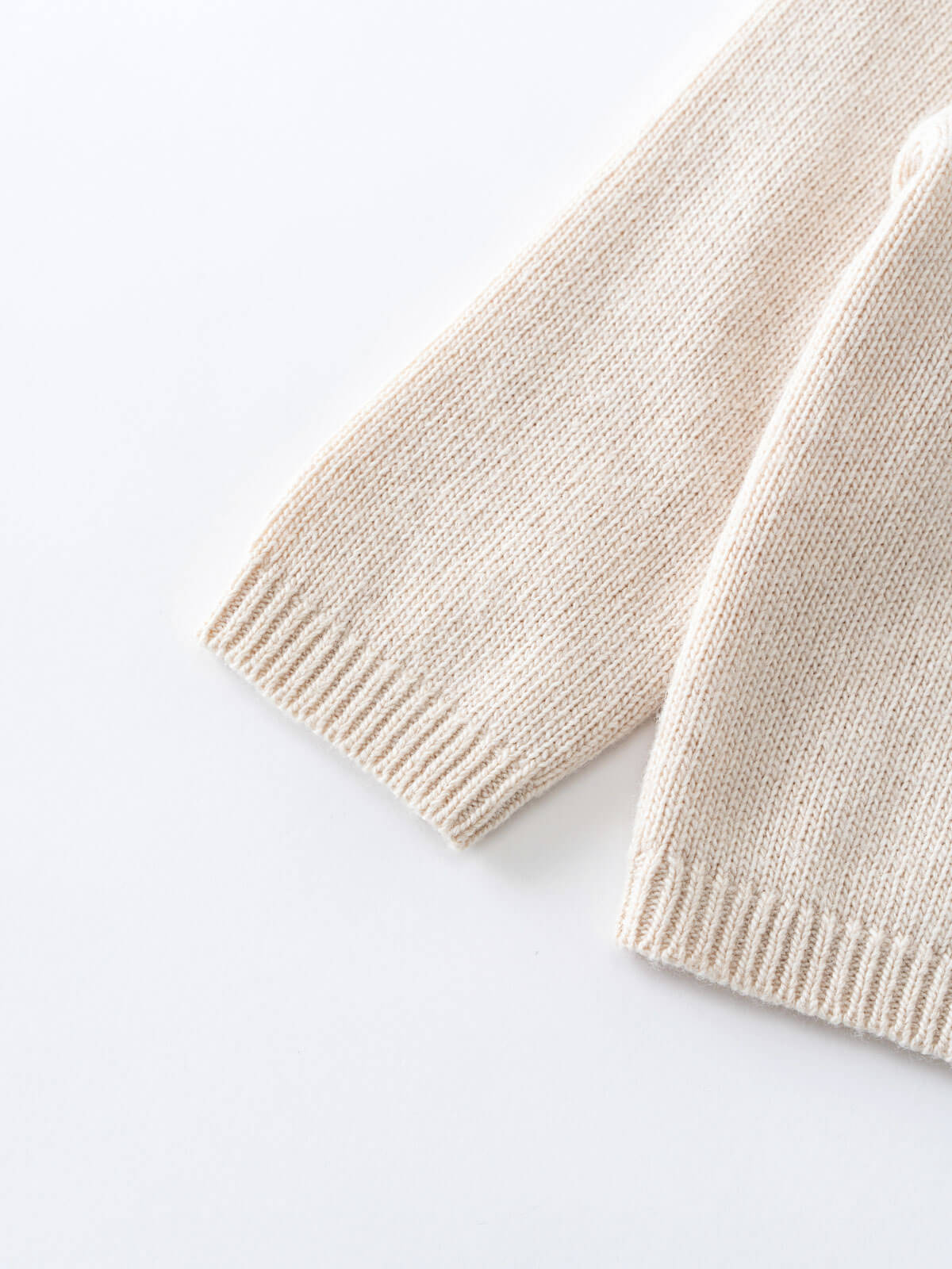 Beige knitted scarf on a white background Baby Ruffle Cardigan - Ecru Baby girl