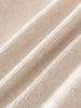 Close-up of beige fabric with a textured pattern Baby Ruffle Cardigan - Ecru Baby girl