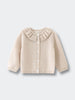 Beige cardigan with ruffled collar on a light gray background Baby Ruffle Cardigan - Ecru Baby girl