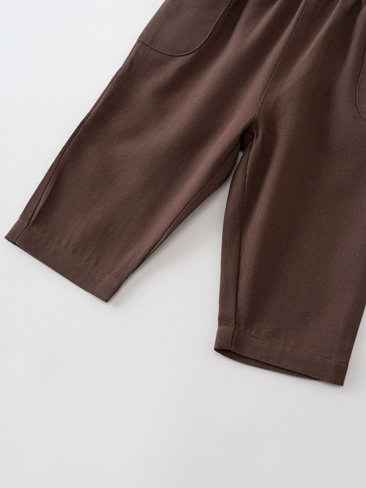 Close-up of brown ribbed fabric pants with visible seams and hem details Baby Twill Pants - Spruce Baby boy