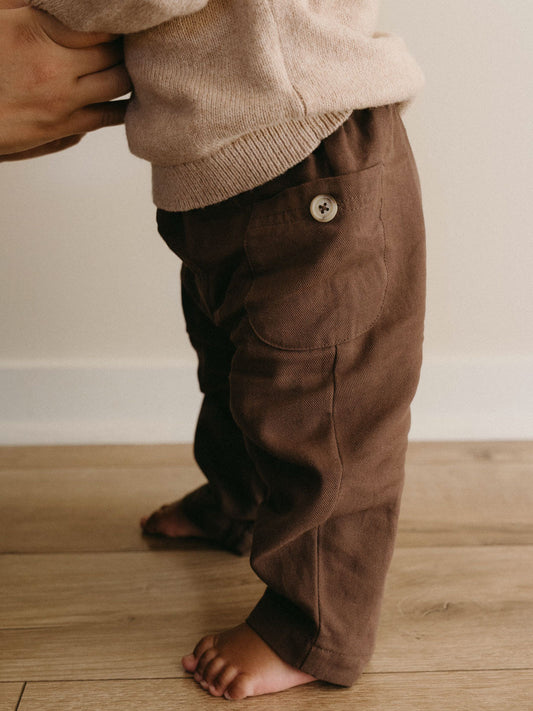 Child wearing brown twill pants with button detail and beige sweater Baby Twill Pants - Spruce Baby boy
