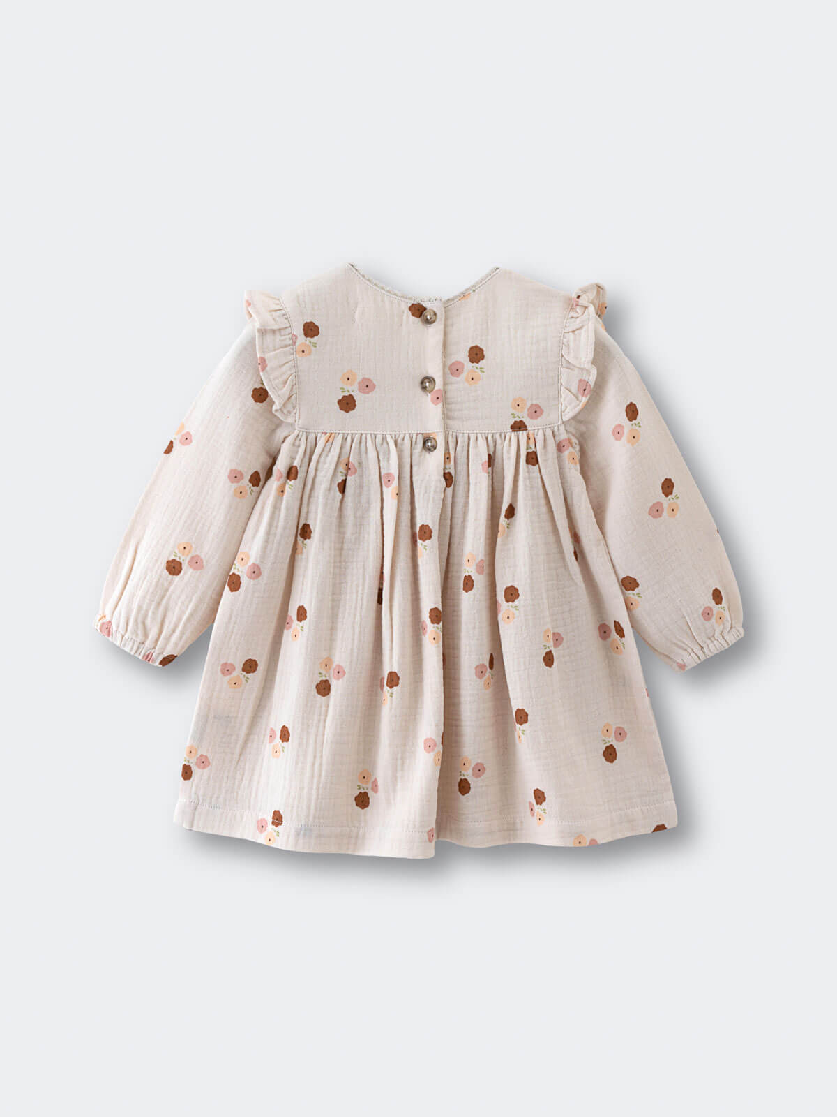 Baby dress with floral pattern with buttons on a white background