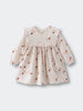 Baby dress with floral pattern on a light gray background