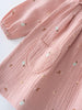 Pink baby dress with small embroidered designs on pockets on a white background Baby Woven Dress - Autumn Harvest Rosehip Baby girl