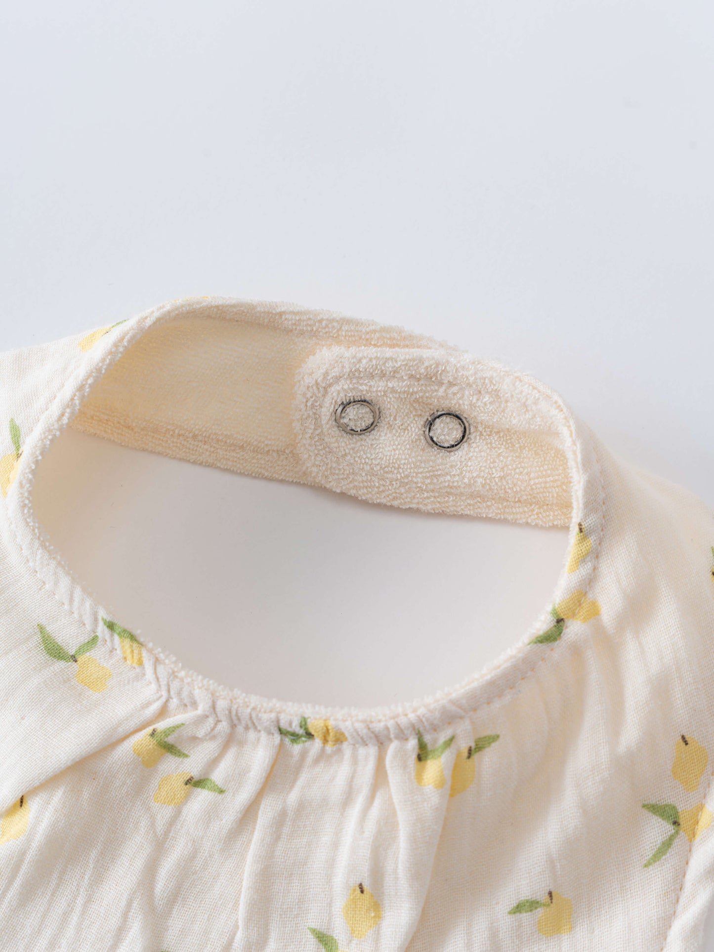 Close-up of a baby bib with lemon print and snap fasteners Bandana Bibs 3 Pack - Lemons Baby girl