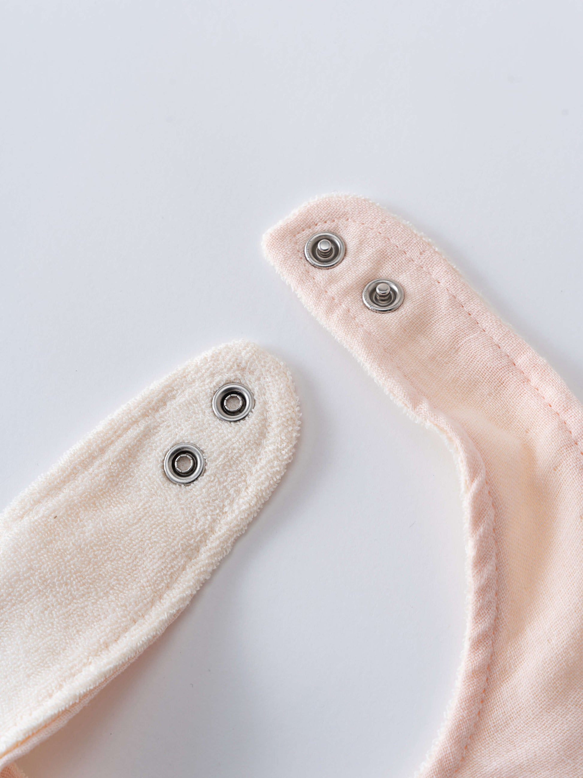 Two beige fabric straps with metal grommets on a light gray background Bandana Bibs 3 Pack - Petal Paws Baby girl