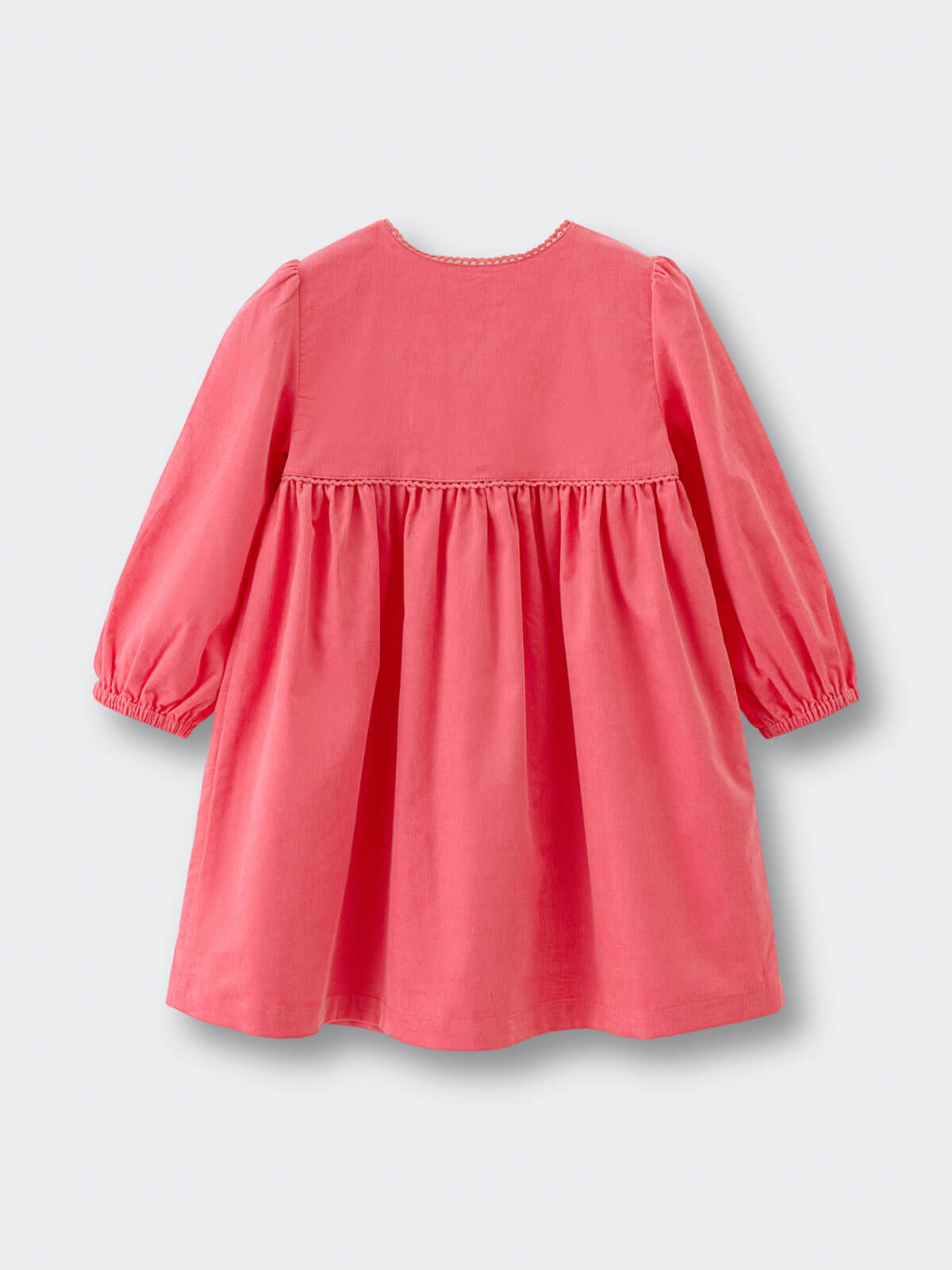 Coral pink dress with long sleeves on a light gray background