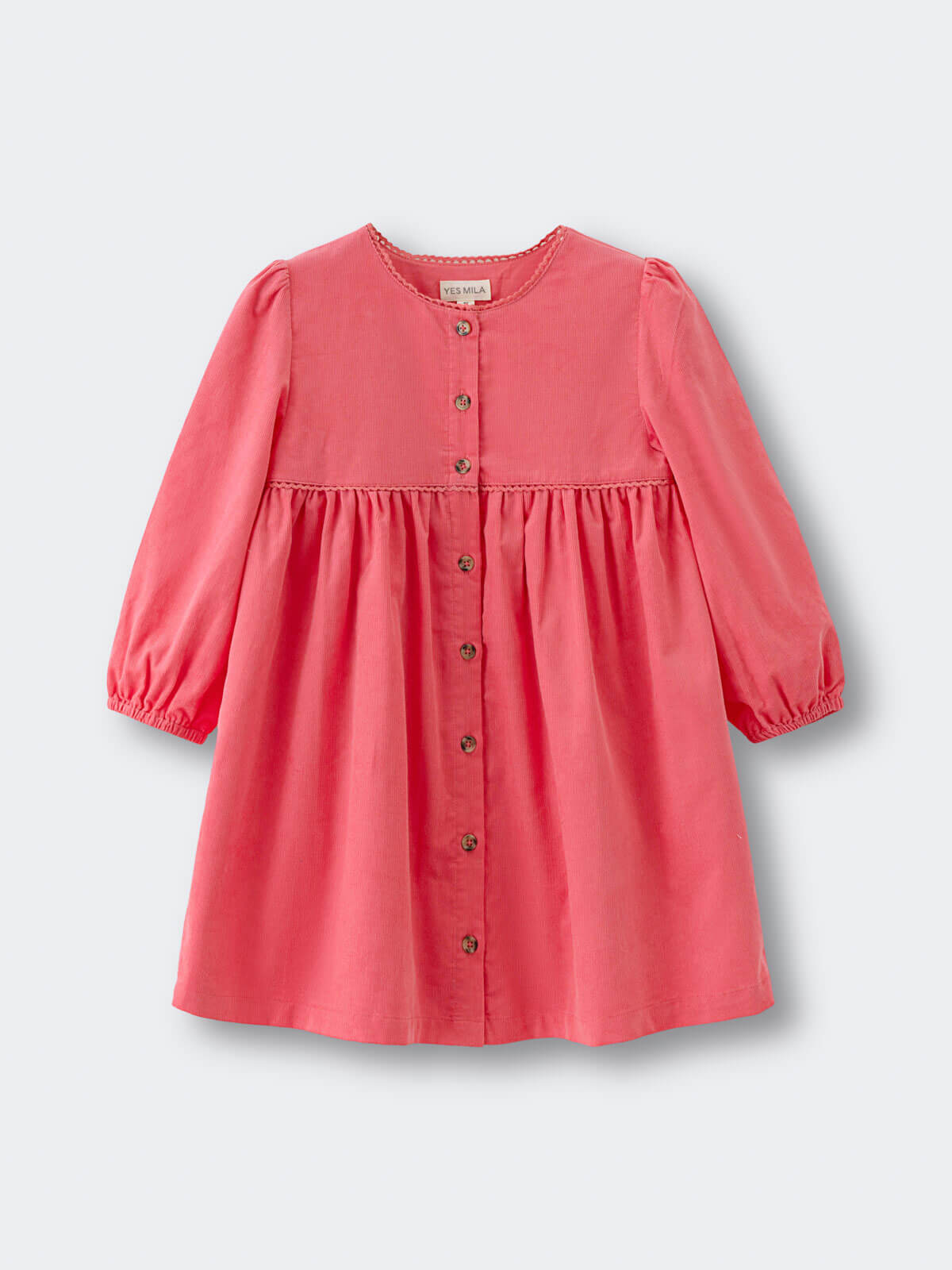 Coral pink dress with buttons on a light gray background