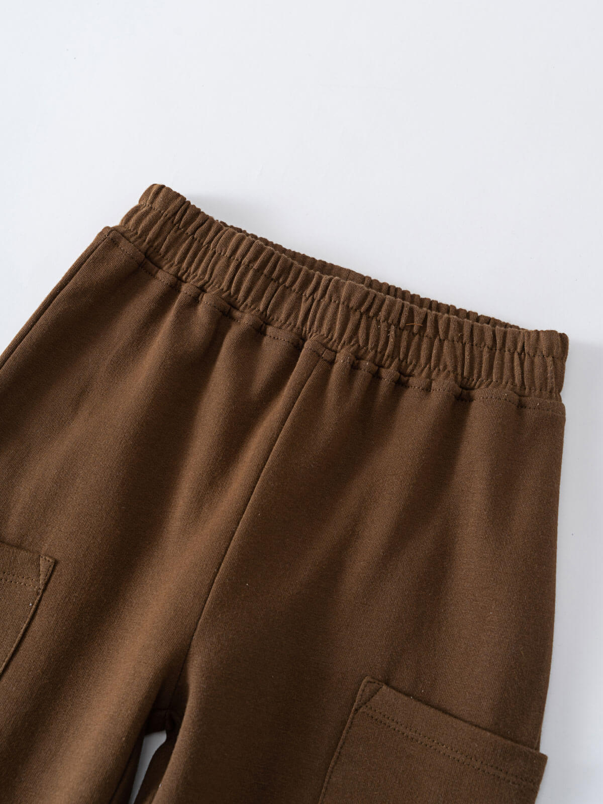 Close-up of brown sweatpants waistband and cargo pockets on fabric Cargo Sweatpants - Spruce Boys