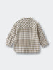 Back view of a checkered shirt on a light gray background