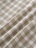 Close-up of plaid shirt with brown and white check pattern