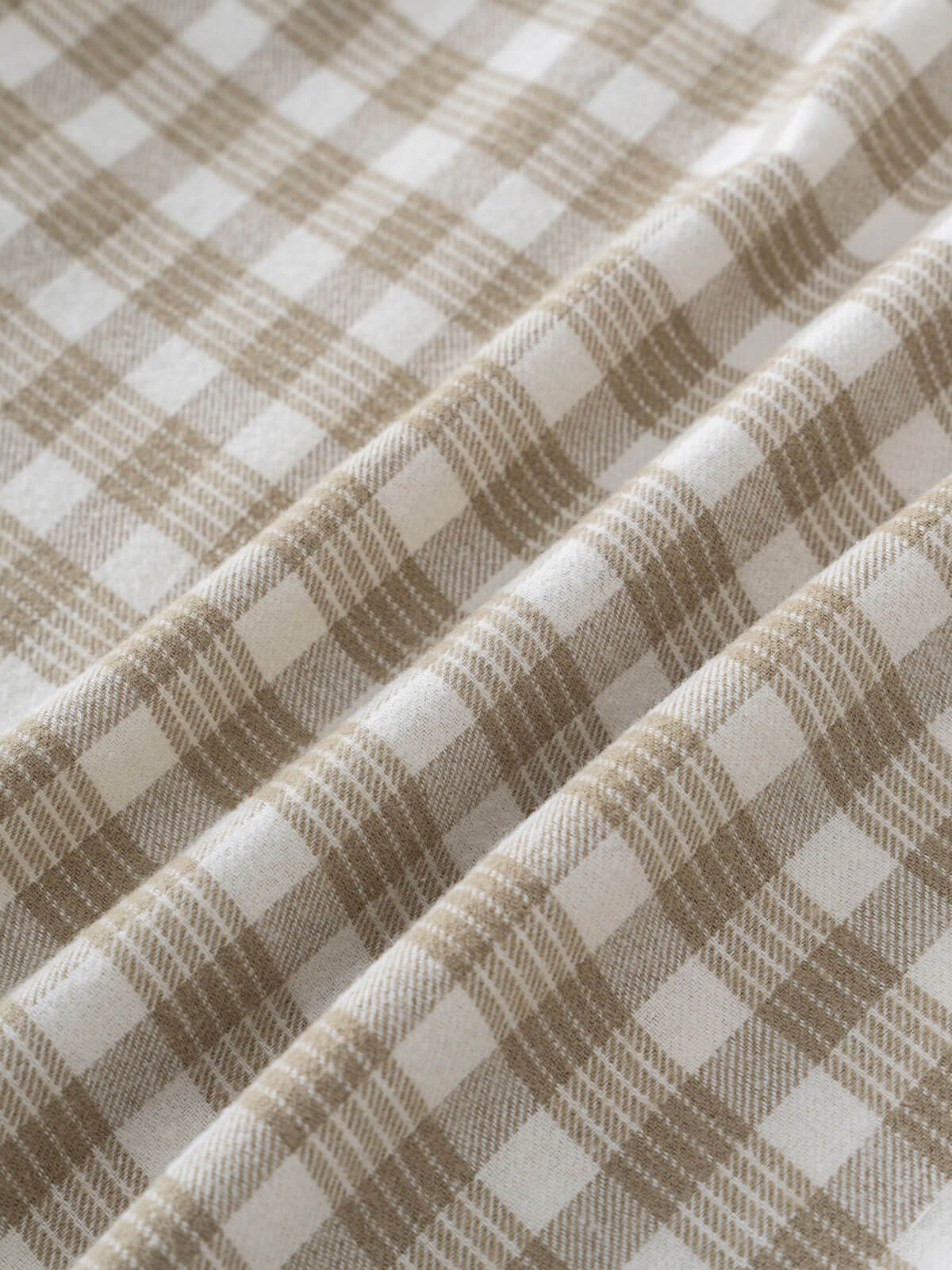 Close-up of plaid shirt with brown and white check pattern
