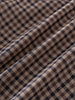 Close-up of checkered shirt fabric with brown, beige, and blue pattern