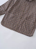 Brown and black checkered shirt on a white background