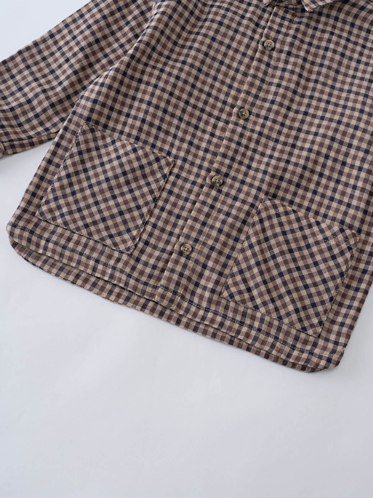 Brown and black checkered shirt on a white background