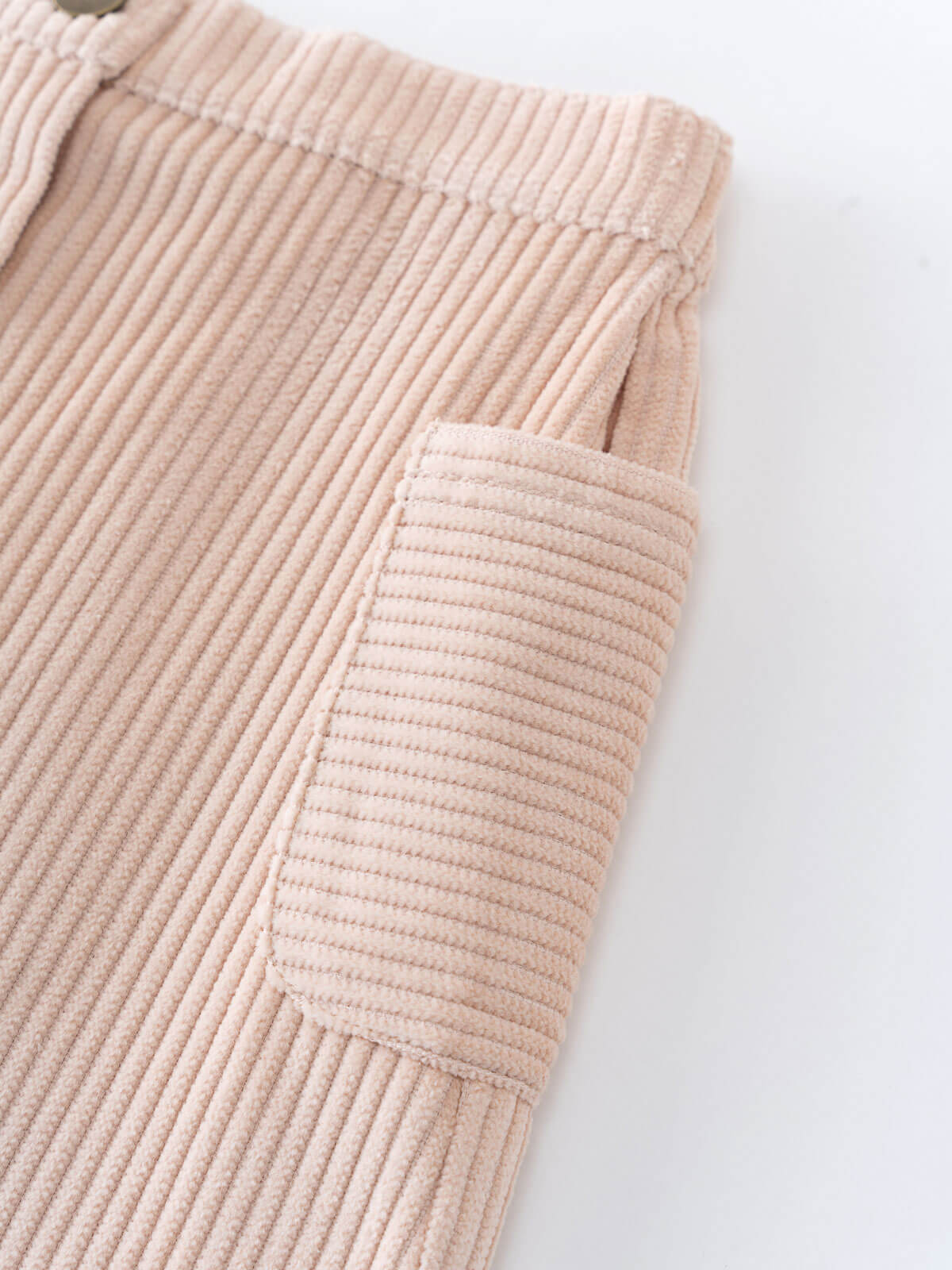 Close-up of a beige corduroy skirt on a white background