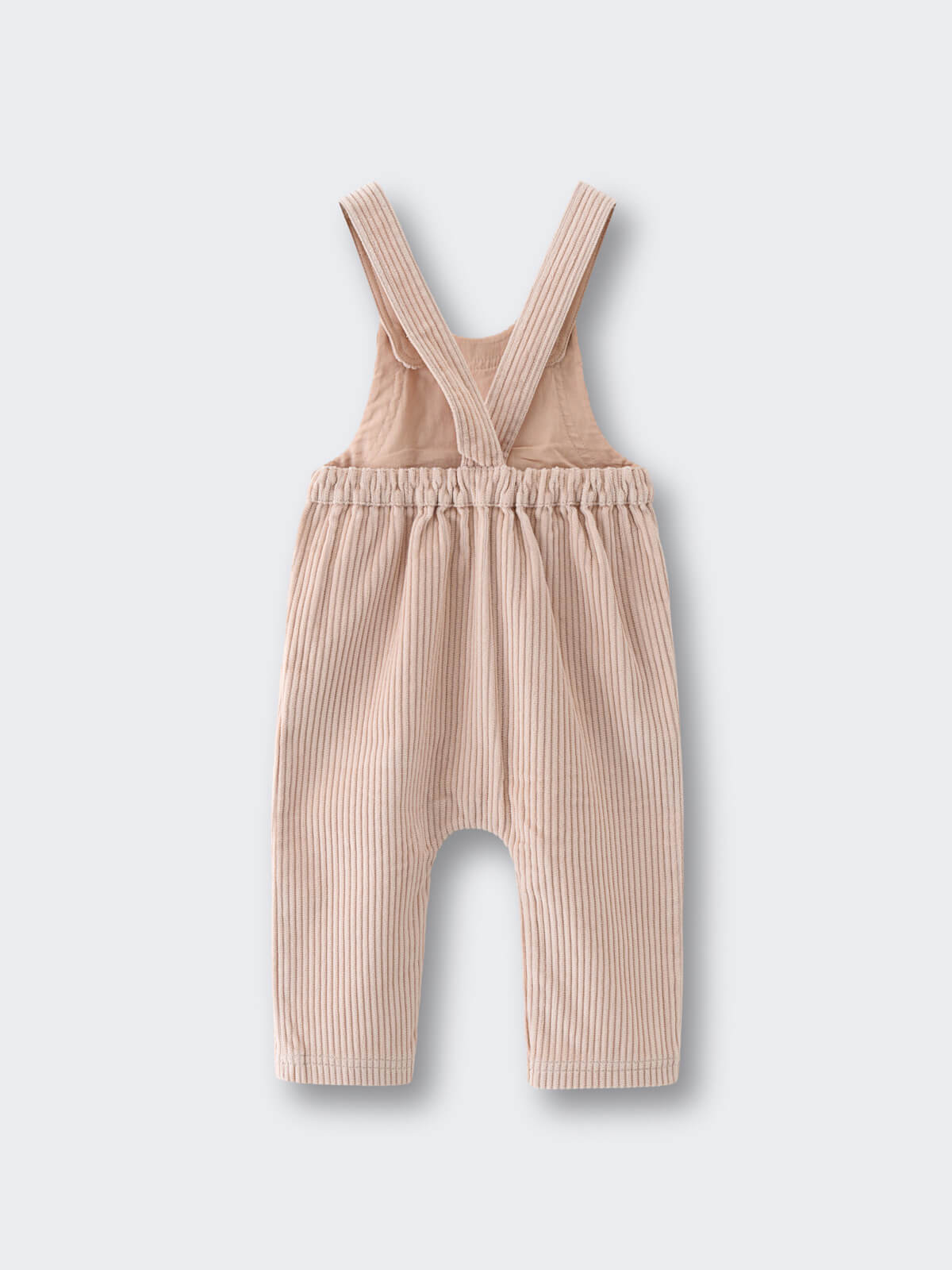 Beige corduroy overalls on a light gray background