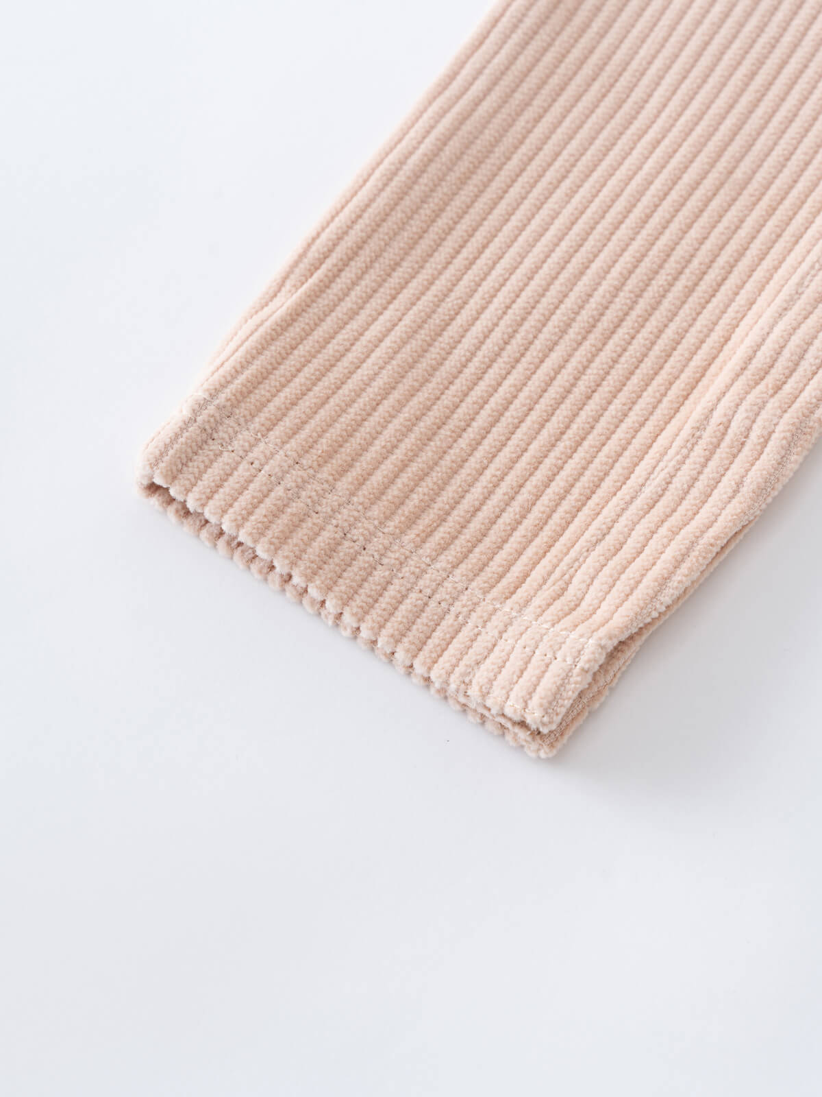 Beige corduroy overalls on a white background
