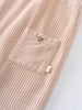Close-up of a beige corduroy overalls with a pocket on a light background