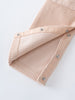 Close-up of a Beige corduroy overalls with button details on a white background