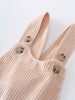 Close-up of a Beige corduroy overalls with button details on a light gray background
