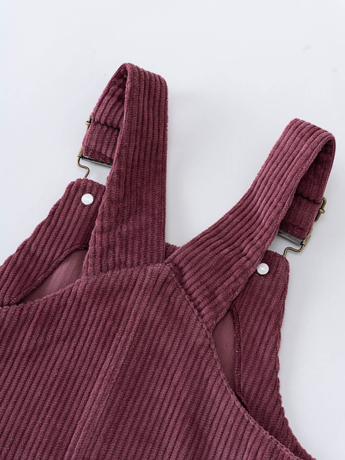 Close-up of a Plum corduroy pinafore dress on a white background Corduroy Pinafore Dress - Plum Jam Girls