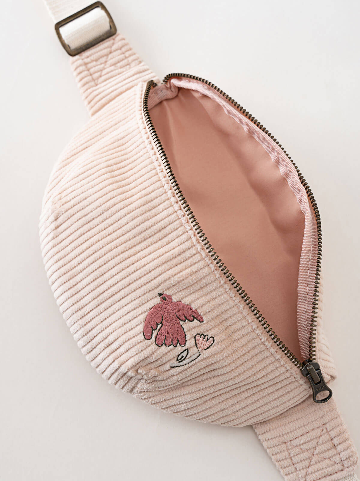 Pink corduroy fanny pack with a zipper on a light gray background Crossbody Bag - Dove Girls