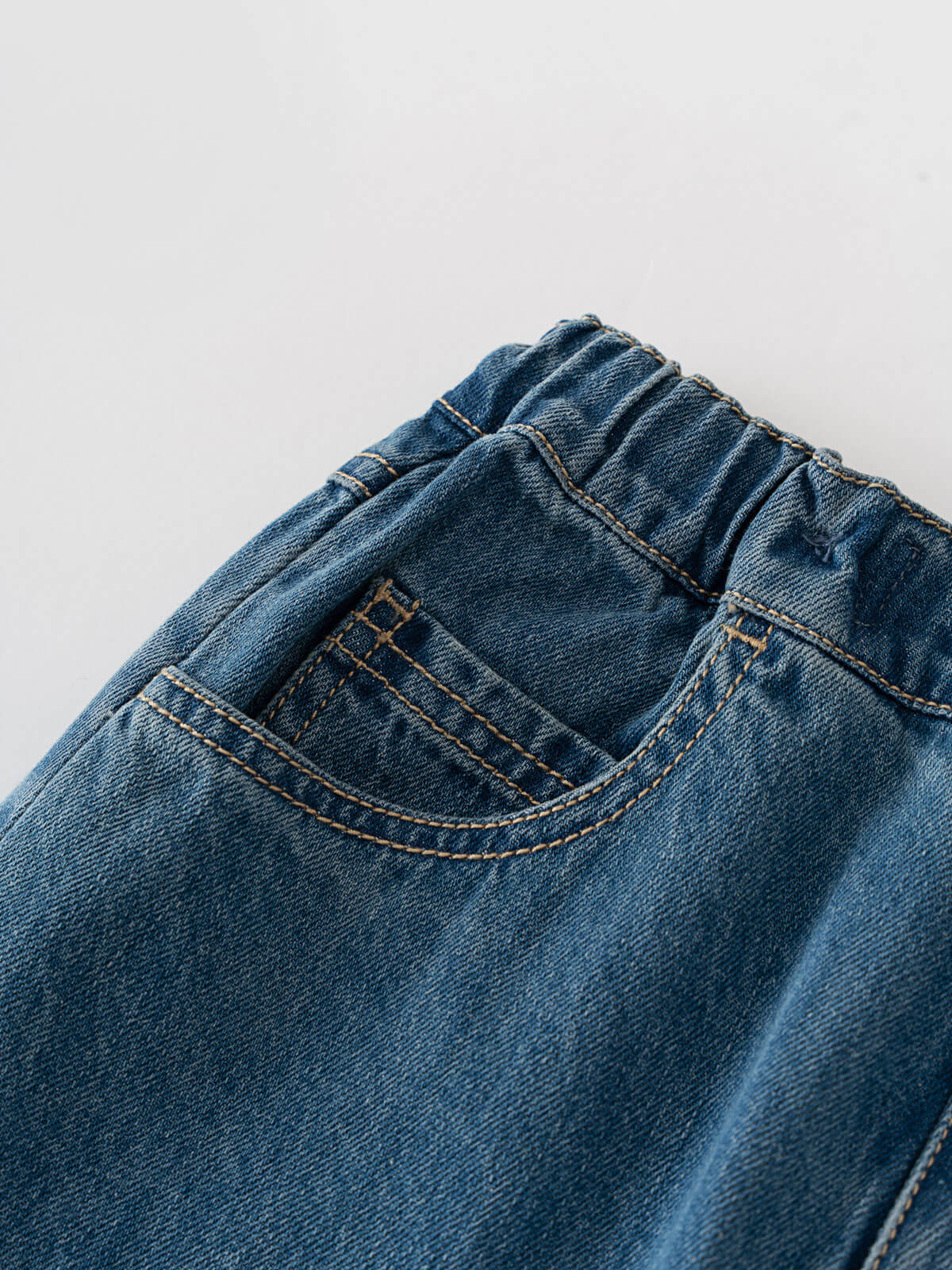 Close-up of blue denim pants showing pocket detail and stitching Denim Pants - Blue Denim Girls and Boys
