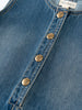 Close-up of a blue denim dress with button details and 'YES MILA' label. Denim Pinafore Dress - Blue Denim Girls
