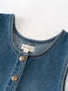 Close-up of a blue denim garment with 'YES MILA' label on a white background Denim Pinafore Dress - Blue Denim Girls