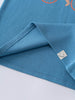 Close-up of blue t-shirt hem with small smiley face label detail feature print Short Sleeve Tee - Milo Biking Boys
