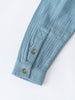 Close-up of a light blue shirt with button details on a white background Grandad Shirt - Lake Blue Boys