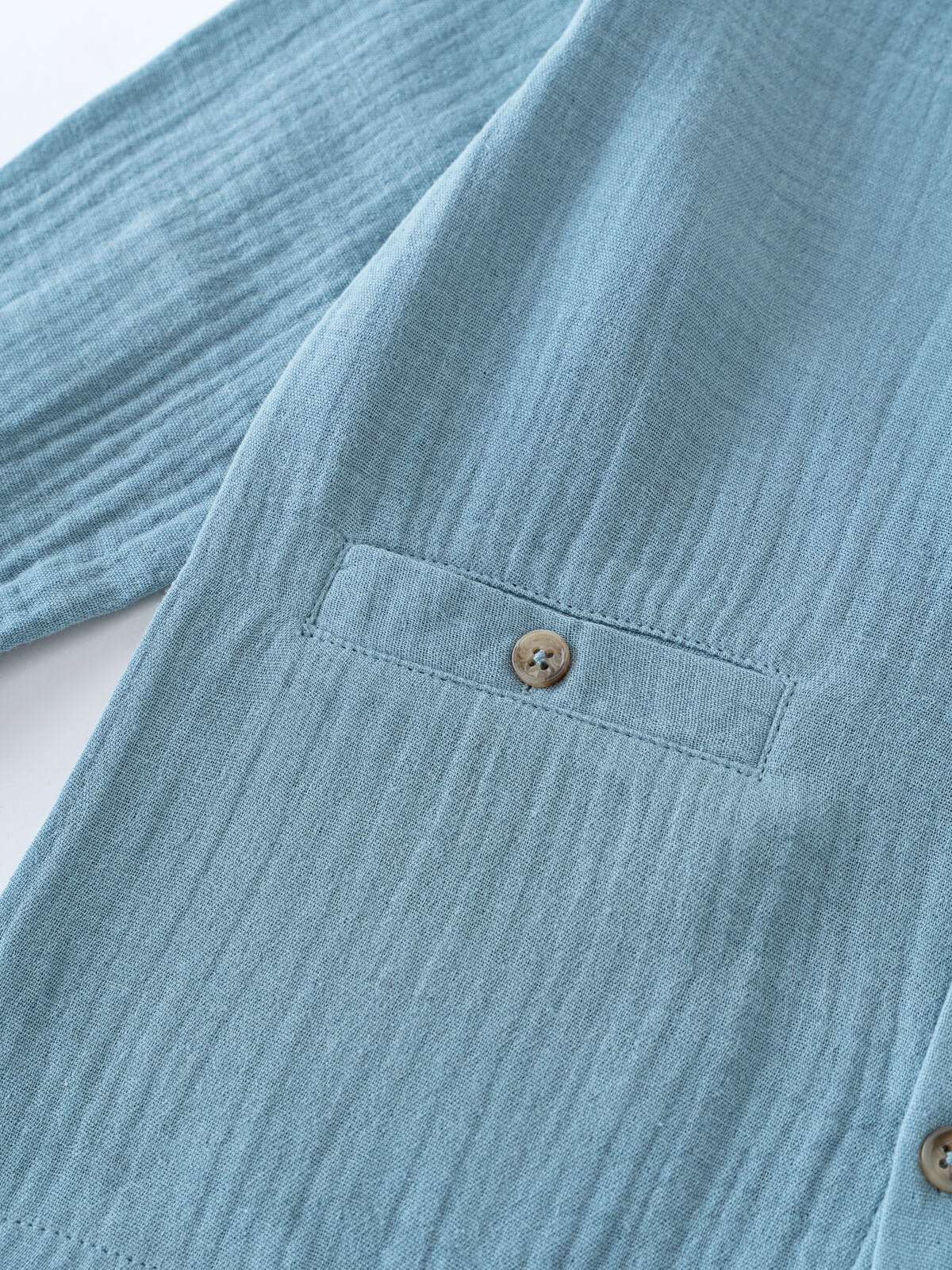 Close-up of a blue shirt with a button on a white background Grandad Shirt - Lake Blue Boys