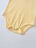 Close-up of a yellow ribbed bodysuit with snap closures at the bottom Henley Short Sleeve Bodysuit- Sun Soaked Baby girl