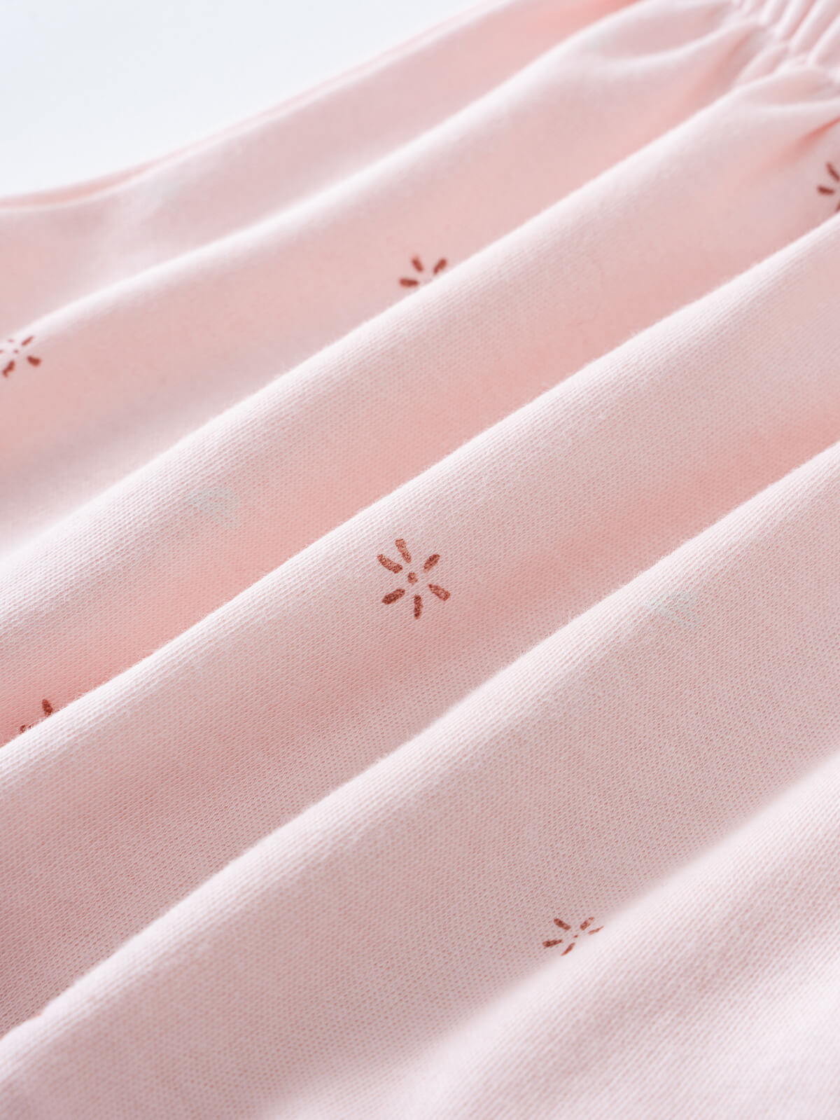 Close-up of pale pink fabric with small embroidered floral details Jersey Skirt - Spring Love Girls