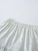 Close-up of a light green skirt with small peach and cherry embroidery Jersey Skirt - Summer Fruits Girls