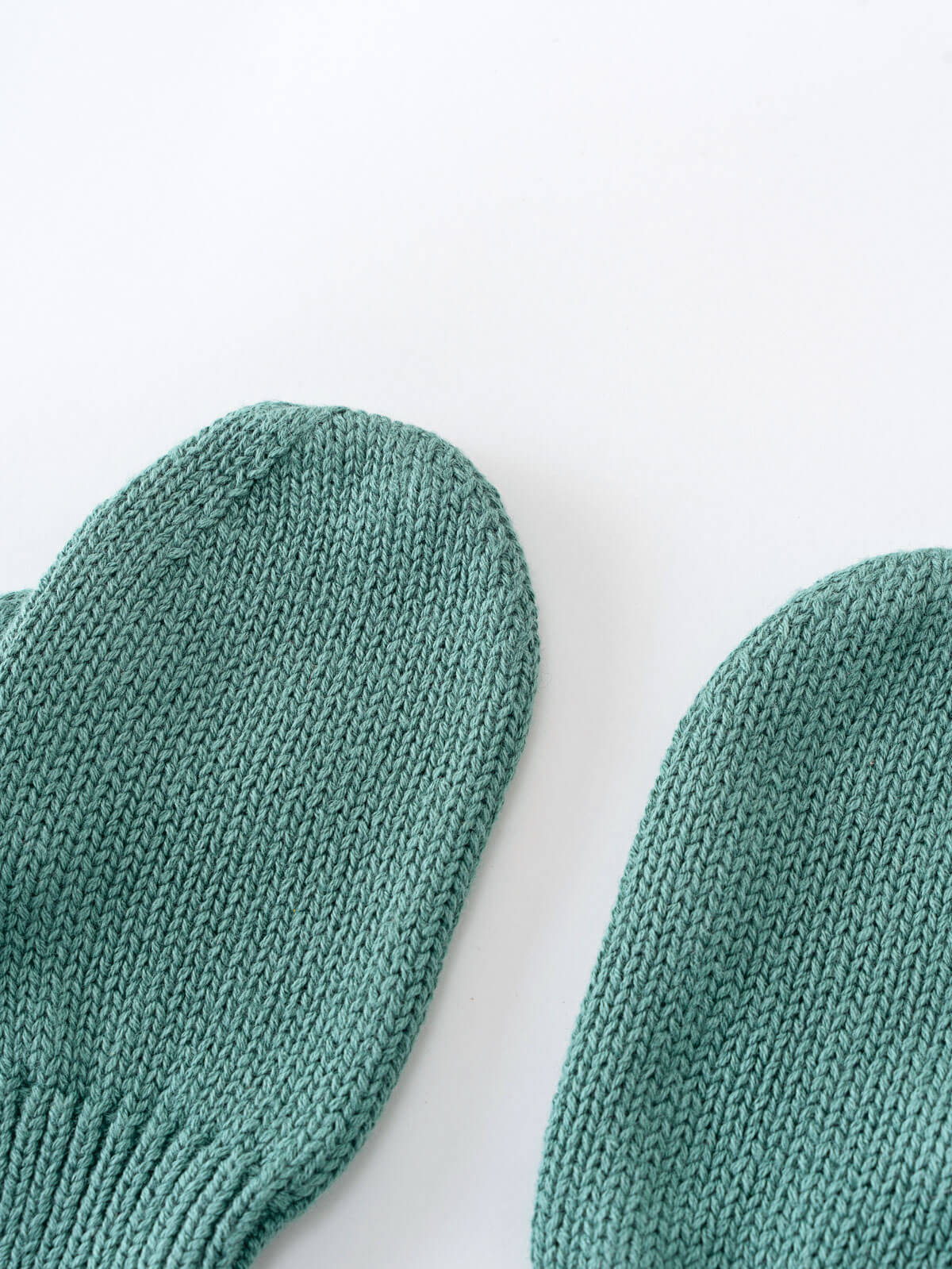 Pair of teal mittens on a white background Knit Mittens - Balsam Boys