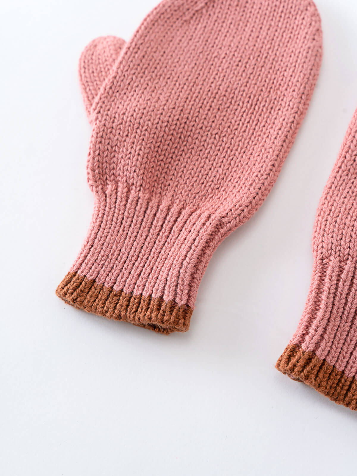 Pair of pink knitted mittens with brown cuffs on a white background Knit Mittens - Rosehip Girls