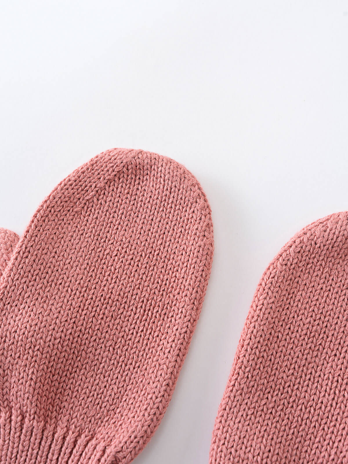 Pair of pink knitted mittens on a light gray background Knit Mittens - Rosehip Girls