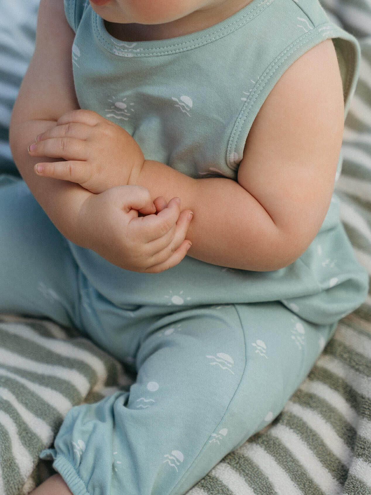 Baby in light blue outfit sitting on a striped surface Leo Romper - Summer Time Baby boy