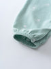 Close-up of light blue fabric sleeve cuff with elastic gathering and white polka dots Leo Romper - Summer Time Baby boy