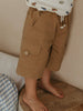 Child wearing tan cargo shorts with button pocket and printed shirt indoors Luca Shorts - Biscuit Boys