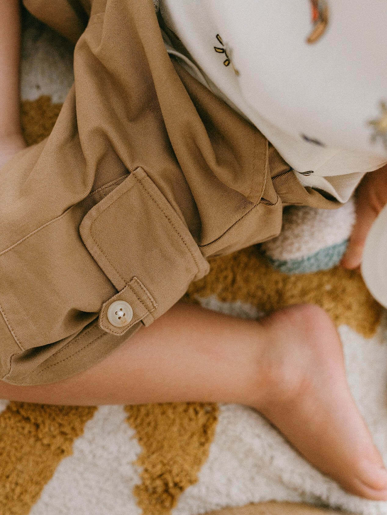 Child wearing tan shorts with button cuff detail and white embroidered shirt Luca Shorts - Biscuit Boys