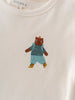 Cream colored shirt with embroidered brown bear wearing blue outfit and yellow boots Feature Print Short Sleeve Tee - Hiking Bear Boys