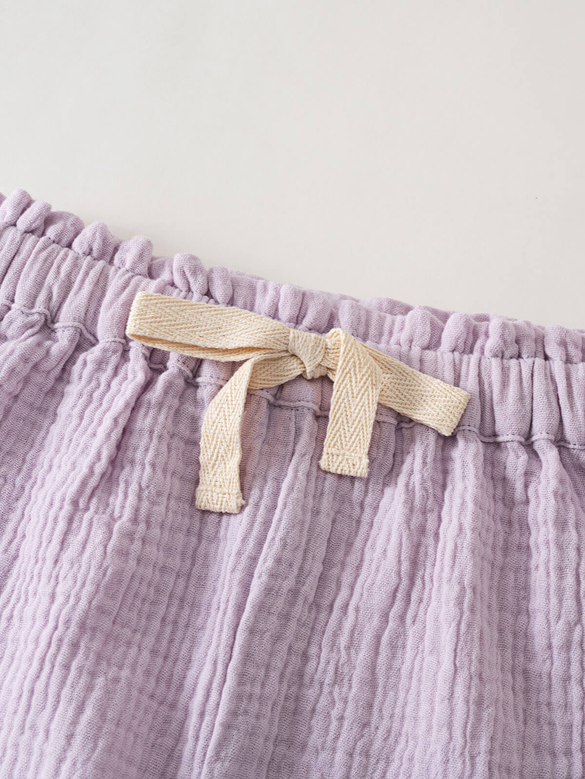 Close-up of elastic waistband with cream drawstring on lilac crinkled fabric shorts Muslin Shorts - Lilac Girls