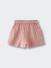 Pink textured shorts with elastic waistband and front pockets on white background Muslin Shorts - Toasted Peach Girls