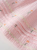 Close-up of pink textured fabric with white wavy trim and small floral embroidery Muslin Skirt - Poppy Field Girls